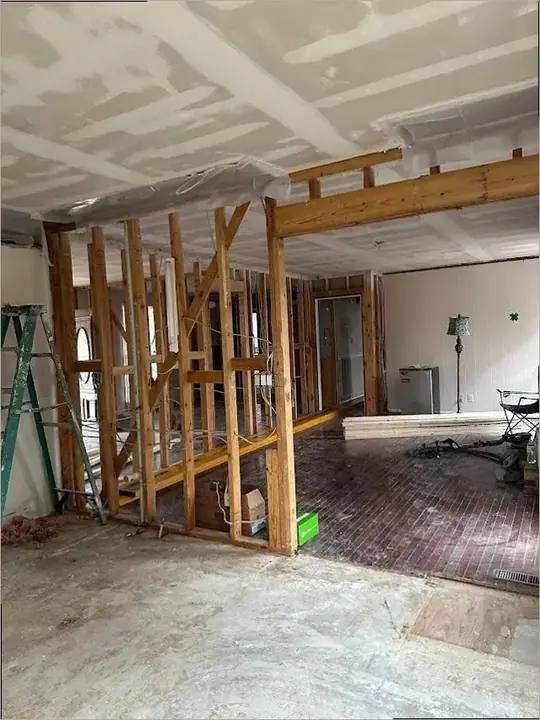 A wall opened to dry the cavity in a Lewisville Lake area home