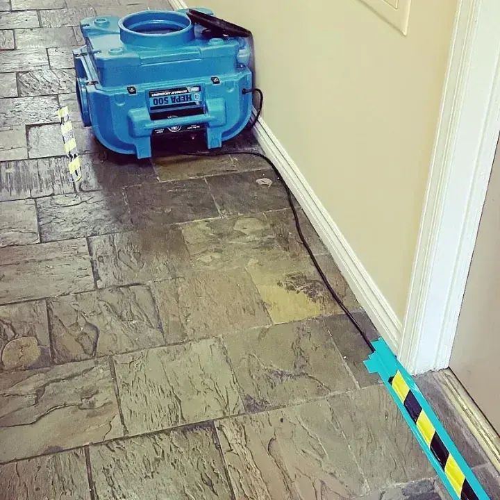 An extractor clearing standing water in a Lewisville Lake area home