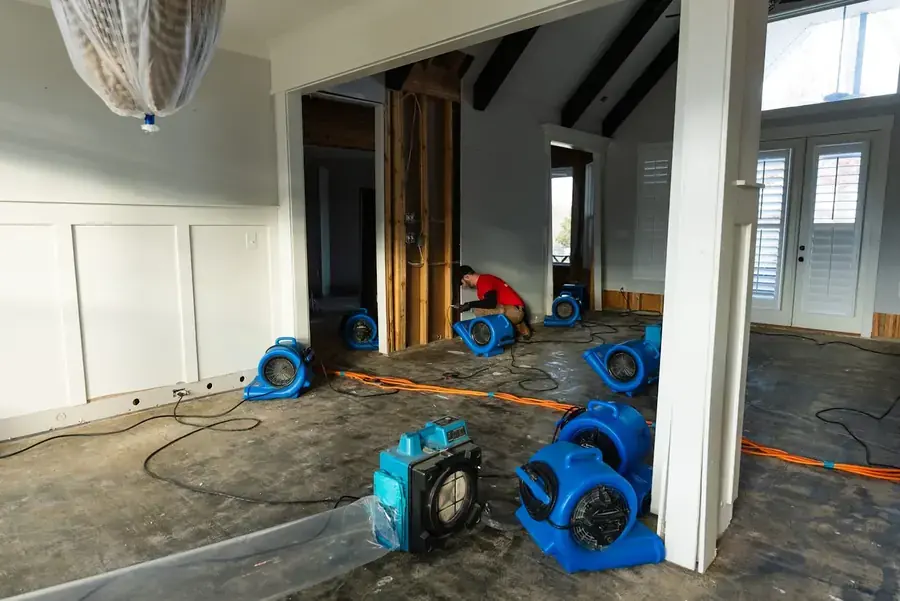 Restoration technician drying a water damaged Lake Dallas, TX home