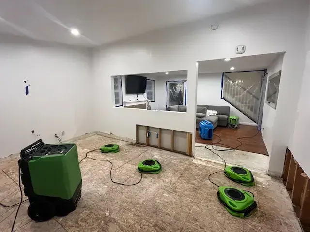 Air movers and dehumidifiers drying a Lake Dallas room